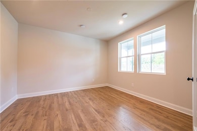 Unfurnished room with hardwood / wood-style floori