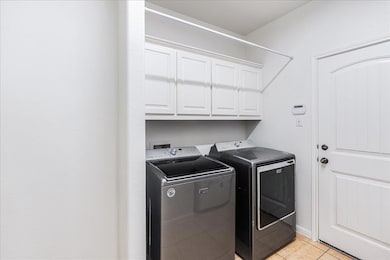 Laundry room featuring light tile patterned floor