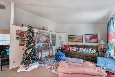 Living area featuring lofted ceiling and carpet