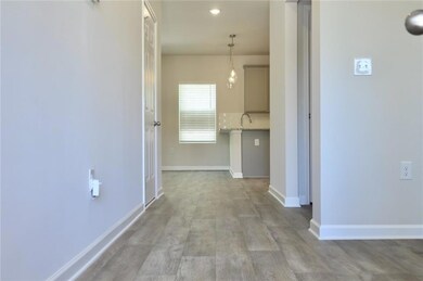 Hall with baseboards and light wood-style flooring