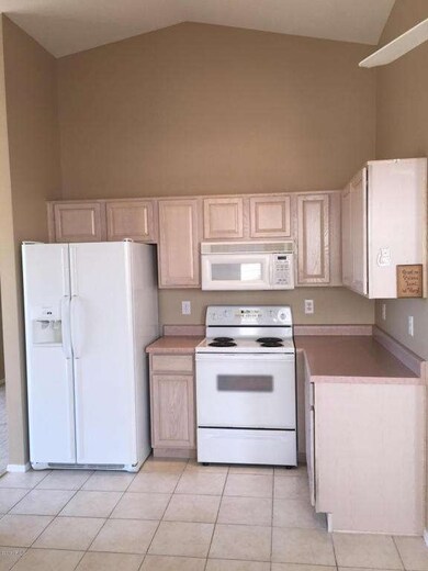 Open kitchen w/ white appliances