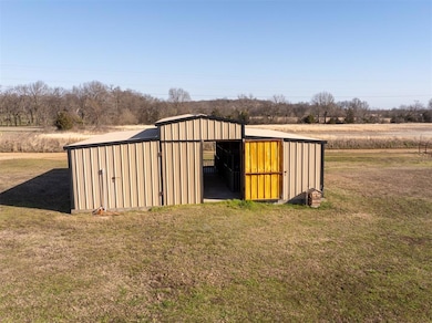 View of pole building with a yard