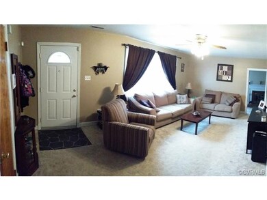Large Living Room with Hardwood under carpet.