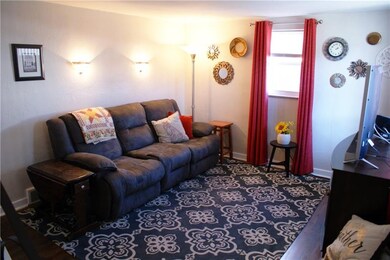 The living room has two large windows, flooding th