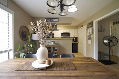 Dining area with plenty of natural light, a chandelier, and light wood finished floors