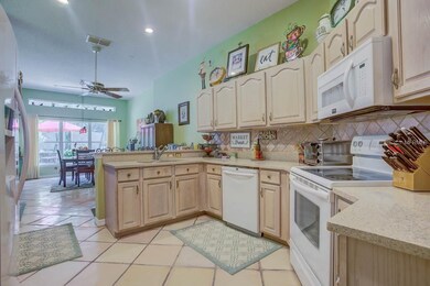 Kitchen area has ample cupboard storage, plus a br