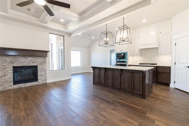 Kitchen with wood finish floors, visible vents, op