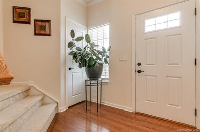 Bright entry foyer with hardwood flooring