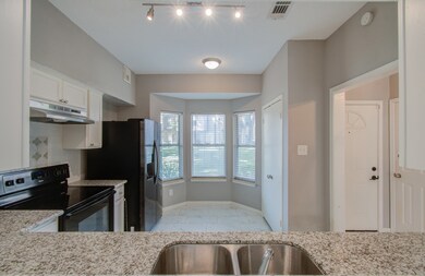 This is a well-lit, modern kitchen featuring stain