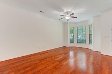 Wonderful great room on the main level featuring a bay window for nice natural light. Ceiling fan and crown molding details.