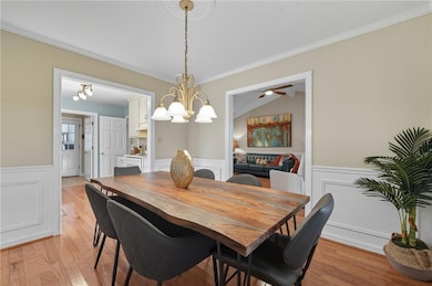 Separate dining area with decorative wall and chandelier