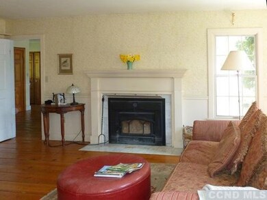 Sitting room with wood stove insert & door into ki