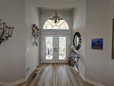 Entryway with a notable chandelier, french doors,