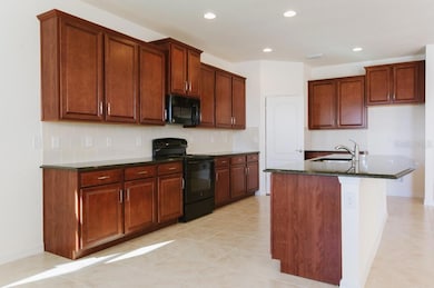 Kitchen with granite counter tops and walk-in pantry
