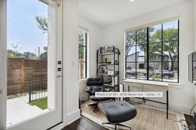 Living area with a healthy amount of sunlight and dark hardwood / wood-style flooring