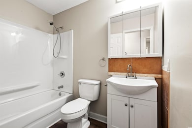 Full bath featuring vanity, toilet, and  shower combination