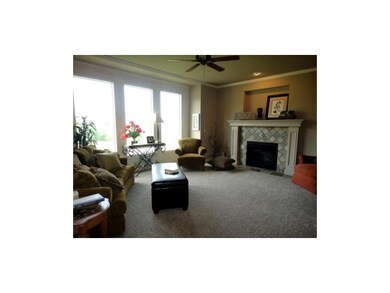 Open living room with a wall of windows, gas firep