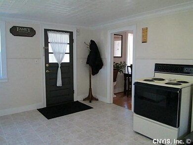Kitchen. Back door leads to enclosed side porch.