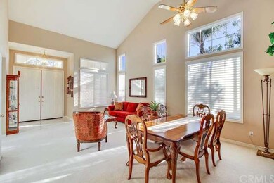 Formal living and dining room with vaulted ceiling