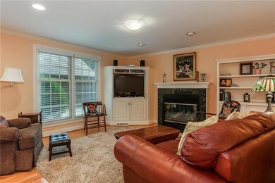 The hearth room offers gleaming hardwood floors, a
