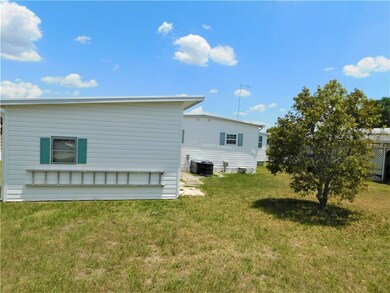 Back of home with large storage building attached.