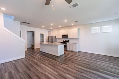 Kitchen with stainless steel appliances, white ca