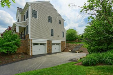 Level driveway leads to spacious double garage com