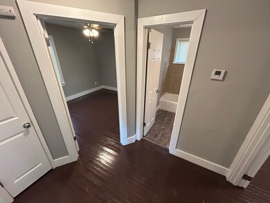 Hallway featuring dark wood-type flooring
