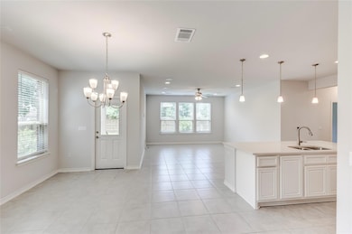 Kitchen with a sink, light countertops, recessed 