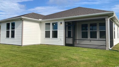 Back of property with a yard