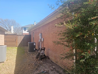 View of side of home featuring brick siding, cooli