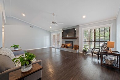 Living area featuring ceiling fan, a fireplace, w