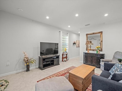 Living room featuring light tile patterned flooring and recessed lighting