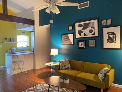 Living area with visible vents, baseboards, a cei