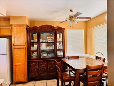 Dining space featuring ceiling fan and light tile
