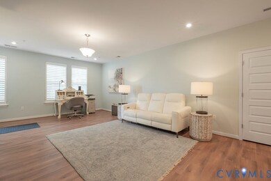 Living room featuring a desk, wood finished floors, and recessed lighting