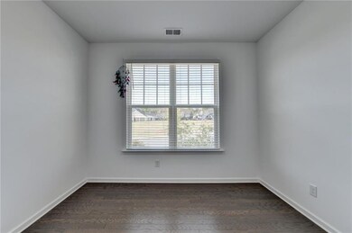 Empty room featuring visible vents, baseboards, an