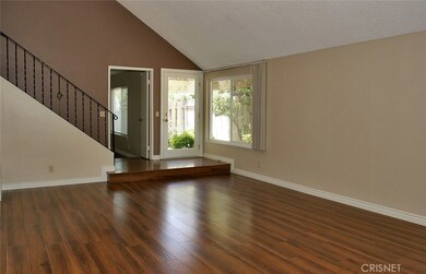 Light and bright family room with newer laminate floors ..entire house has newer vinyl wondows