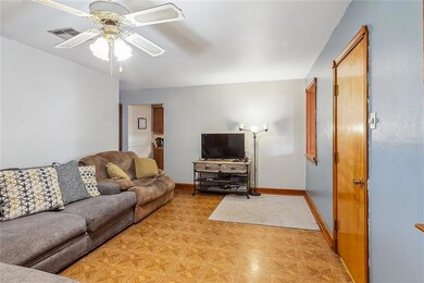 Living room looking toward kitchen. door on right leads to large flexible sroom/space.