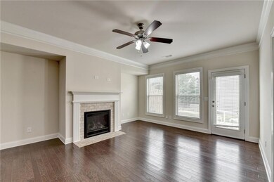 Unfurnished living room featuring a ceiling fan, d