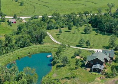 36 beautiful acres with a custom home, a stocked p