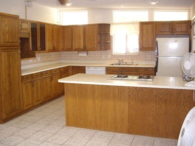 Tiled kitchen with pennisula island.