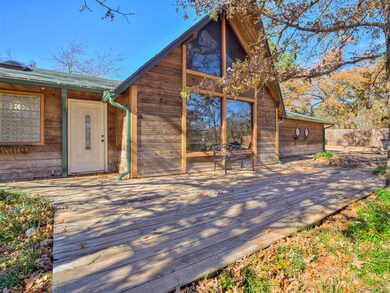 Back of house featuring a wooden deck