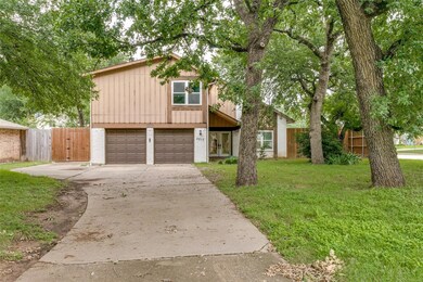 View of front of home featuring a garage and a front yard