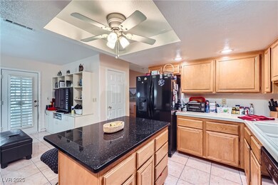 Kitchen featuring black appliances, light tile pat