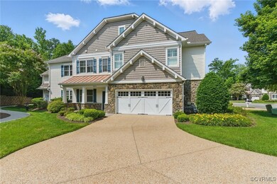 View of front of home with stone siding, driveway,