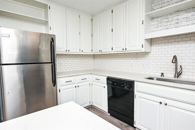 Kitchen featuring freestanding refrigerator, blac