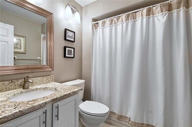 Bathroom featuring vanity, toilet, and curtained s