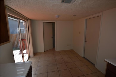Spare room featuring a textured ceiling and light