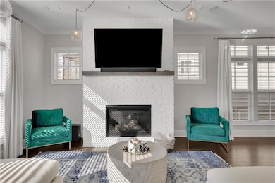 Living room with a fireplace, ornamental molding, 